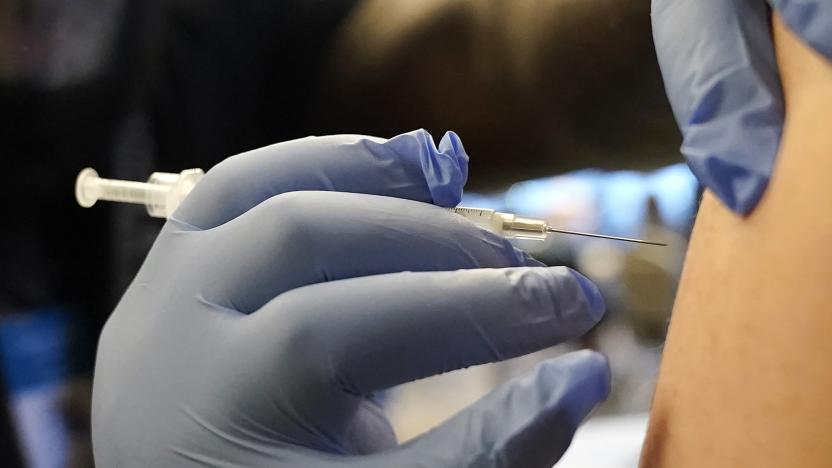 FILE - A person receives a Pfizer COVID-19 vaccine booster shot, Dec. 20, 2021, in Federal Way, Wash. On Sept. 1, 2023, The Associated Press reported on stories circulating online incorrectly claiming that the U.S. Centers for Disease Control and Prevention said that a new COVID-19 variant is more contagious among vaccinated people than those who are unvaccinated. (AP Photo/Ted S. Warren, File)