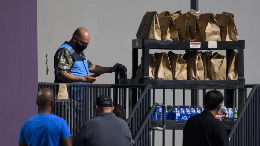 An Amazon.com Inc. delivery driver pushes a cart of groceries to load into a vehicle outside of a distribution facility on February 2, 2021 in Redondo Beach, California. - Jeff Bezos said February 1, 2021, he would give up his role as chief executive of Amazon later this year as the tech and e-commerce giant reported a surge in profit and revenue in the holiday quarter. The announcement came as Amazon reported a blowout holiday quarter with profits more than doubling to $7.2 billion and revenue jumping 44 percent to $125.6 billion. (Photo by Patrick T. FALLON / AFP) (Photo by PATRICK T. FALLON/AFP via Getty Images)