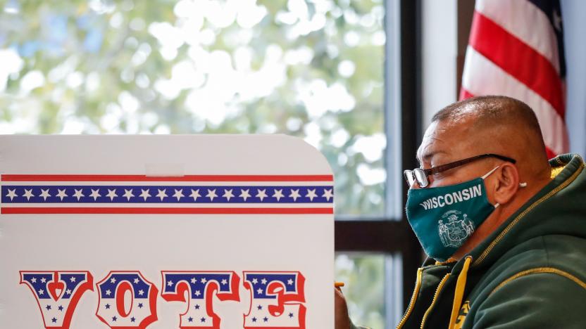 A man casts his ballot at Tippecanoe Library on the first day of in-person early voting for the November 3rd elections in Milwaukee, Wisconsin, on October 20, 2020. - Early voting kicked off October 20, 2020 in Wisconsin, a state fought over by President Donald Trump and Democratic challenger Joe Biden as their contentious White House race enters its final 14-day stretch. (Photo by KAMIL KRZACZYNSKI / AFP) (Photo by KAMIL KRZACZYNSKI/AFP via Getty Images)