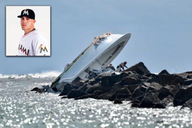 Investigators inspect the overturned boat as it rests on a jetty after the crash that killed Jose Fernandez and two others on early Sunday morning. (AP Photo)