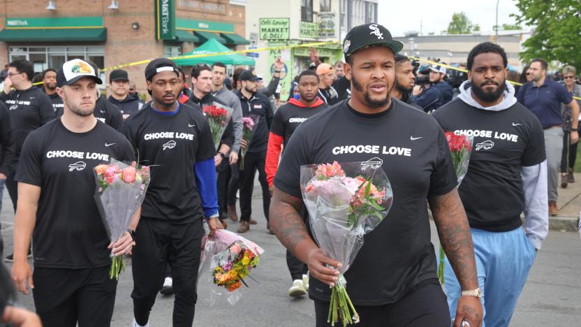 BUFFALO, NEW YORK - MAY 18: Members of the Buffalo Bills visit a memorial near the Tops supermarket where ten people were killed last Saturday on May 18, 2022 in Buffalo, New York. Members of the team laid flowers and greeted residents and fans during their visit to the area. A gunman opened fire at the store killing ten people and wounding another three. The attack was believed to be motivated by racial hatred.  (Photo by Scott Olson/Getty Images)