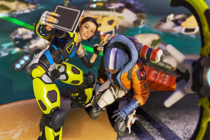 Apex Legends character Conduit takes a selfie with a downed opponent.