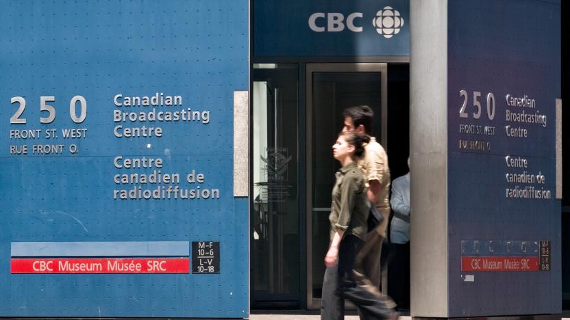 Pedestrians walk in front of the Canadian Broadcasting Corporation (CBC) building in downtown Toronto on June 7, 2006.