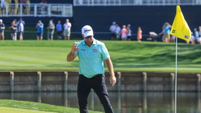 Getty Images - PONTE VEDRA BEACH, FLORIDA - MARCH 14: Ryan Fox of New Zealand acknowledges the crowd after picking his ball out of the hole after holing his tee shot on the 17th hole for a hole in one during the first round of THE PLAYERS Championship on the Stadium Course at TPC Sawgrass on March 14, 2024 in Ponte Vedra Beach, Florida. (Photo by David Cannon/Getty Images)