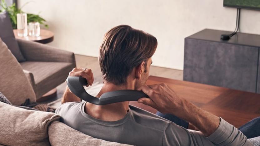 A man seen from behind as he puts on the Sony SRS-NS7 wireless neckband speaker.