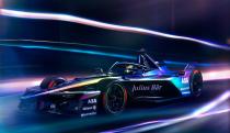 Formula E Gen3 Evo race car in motion with blurred lights all around it. 