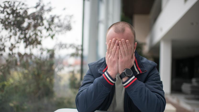 High class businessman worried and without any hope sitting in a cafe.