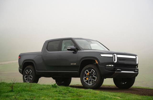 A dark gray truck parked on the grass.