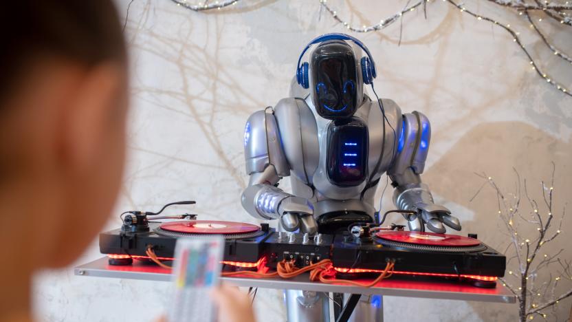 Robot dj. Girl making a selfie of her digital friend standing near dj table