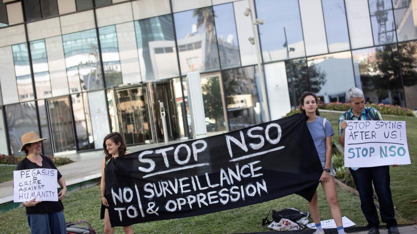 Protestors hold placards and a banner during a protest attended by about a dozen people outside the offices of the Israeli cyber firm NSO Group in Herzliya near Tel Aviv, Israel July 25, 2021. REUTERS/Nir Elias