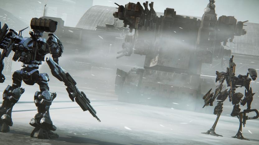 Gameplay screenshot from ‘Armored Core VI: Fires of Rubicon.’ A mech (facing away from the camera) stands to the left of the screen, with a smaller one to the right. A huge tank looms in the background, dominated by bleak, industrial grays.