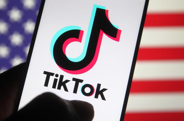 UKRAINE - 2020/10/08: In this photo illustration, a TikTok Chinese video-sharing social networking service logo seen displayed on a smartphone with a flag of the United States in the background. (Photo Illustration by Pavlo Gonchar/SOPA Images/LightRocket via Getty Images)