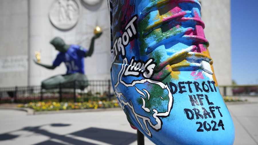 Associated Press - An NFL football draft cleat is displayed near the Spirit of Detroit statue, Friday, April 19, 2024, in Detroit. The draft has taken the show on the road for a decade, giving cities a chance around the country a chance to be in the spotlight. (AP Photo/Carlos Osorio)