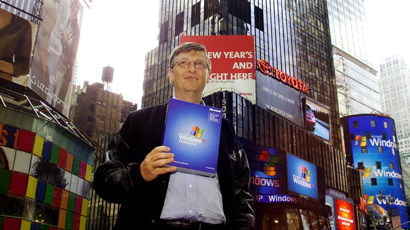 Bill Gates, Chairman and Chief Software Architect of Microsoft holds a copy of Microsoft's Windows XP in New York's Times Square October 25, 2001. Microsoft held a launch event for the new operating system in a near by theater. (Photo by Jeff Christensen/WireImage)