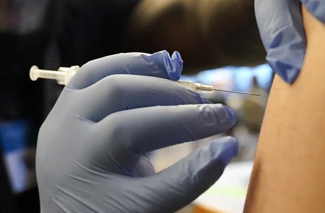 FILE - A person receives a Pfizer COVID-19 vaccine booster shot, Dec. 20, 2021, in Federal Way, Wash. On Sept. 1, 2023, The Associated Press reported on stories circulating online incorrectly claiming that the U.S. Centers for Disease Control and Prevention said that a new COVID-19 variant is more contagious among vaccinated people than those who are unvaccinated. (AP Photo/Ted S. Warren, File)