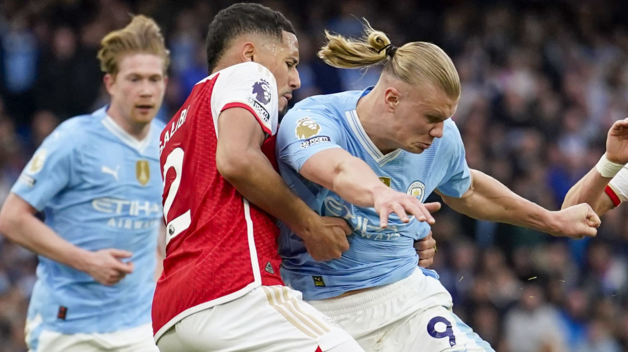 Associated Press - Manchester City's Erling Haaland, center right, duels for the ball with Arsenal's William Saliba during the English Premier League soccer match between Manchester City and Arsenal at the Etihad stadium in Manchester, England, Sunday, March 31, 2024. (AP Photo/Dave Thompson)