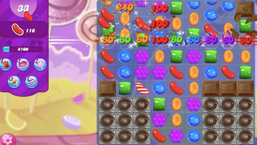 A screenshot of a mobile game showing cartoon candies in a grid.