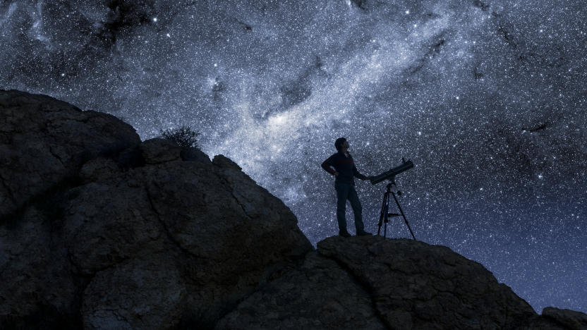 Man Stargazing in Desert
