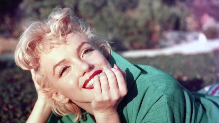 PALM SPRINGS, CA - 1954: Actress Marilyn Monroe poses for a portrait laying on the grass in 1954 in Palm Springs, California. (Photo by Baron/Getty Images)