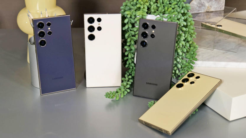 Four Samsung S24 Ultra phones lean against small desktop props with their rear camera side showing and showing the four muted tone colorways.