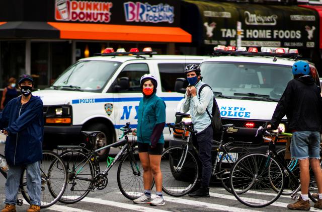 Demonstrators block the NYPD vans to follow them with their bikes as they take part in a protest against racial inequality and in support of the Black Lives Matter movement in Brooklyn, New York, U.S., August 16, 2020. REUTERS/Eduardo Munoz