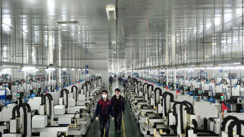 This picture taken on March 12, 2015 shows employees working in the workshop of Lens Technology in Liuyang, central China's Hunan province. Zhou Qunshu, a former factory worker who founded Lens Technology , a company supplying Apple, Samsung and other technological giants with touchscreen glass has become China's richest woman, reports said, with a fortune surpassing 8 billion USD.   CHINA OUT     AFP PHOTO        (Photo credit should read STR/AFP via Getty Images)