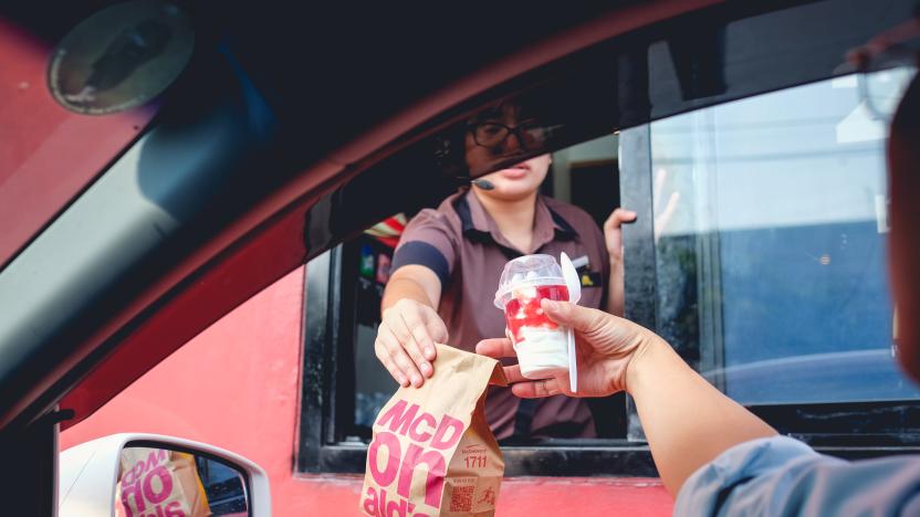 Bangkok, Thailand - Mar 4, 2017: Unidentified customer receiving hamburger and ice cream after order and buy it from McDonald's drive thru service, McDonald's is an American fast food restaurant chain