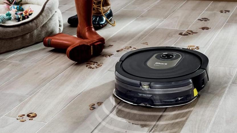 The Shark vacuum cleans a dirty wood floor. 