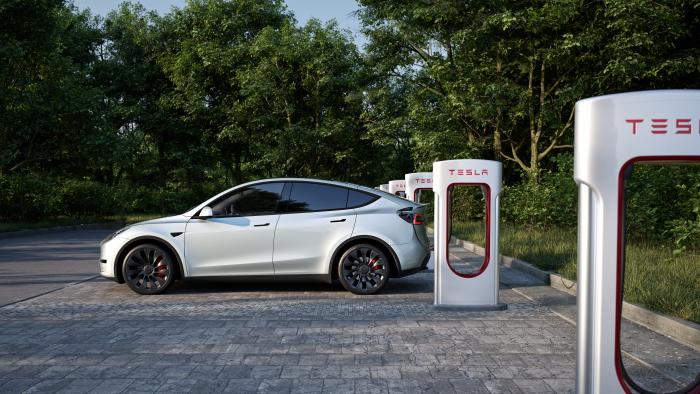 A Tesla car charges at a Supercharger station.