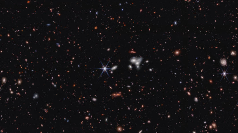 A photo of space with distant galaxies against a black background. 