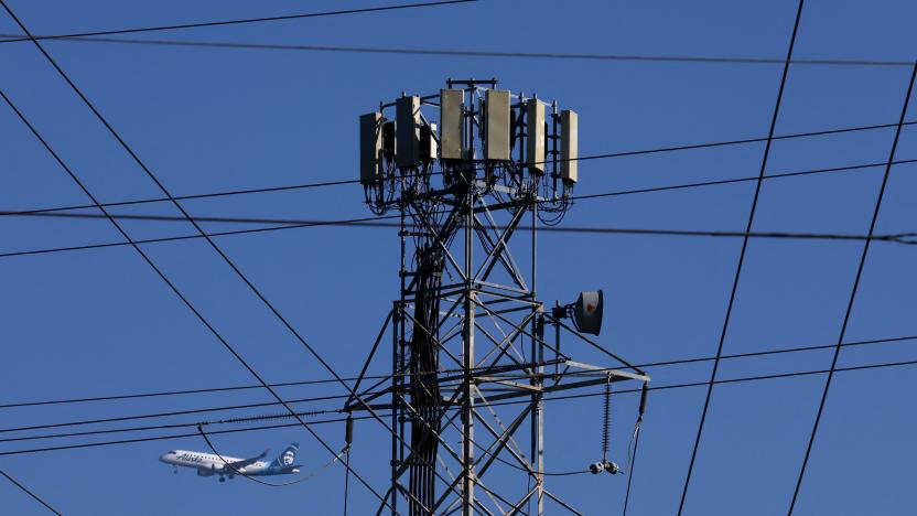 SAN MATEO, CALIFORNIA - JANUARY 18: An Alaska Airlines plane flies by a cellular tower as it prepares to land at San Francisco International Airport on January 19, 2022 in San Mateo, California. Verizon and AT&T announced that they will proceed with plans to activate 5G cellular service across the nation on Wednesday with the exception of near airports and runways after the Federal Aviation Administration and major airlines warned that the signal could interfere with navigational systems on some planes and cause flight disruptions.   Justin Sullivan/Getty Images/AFP / AFP / GETTY IMAGES NORTH AMERICA / JUSTIN SULLIVAN