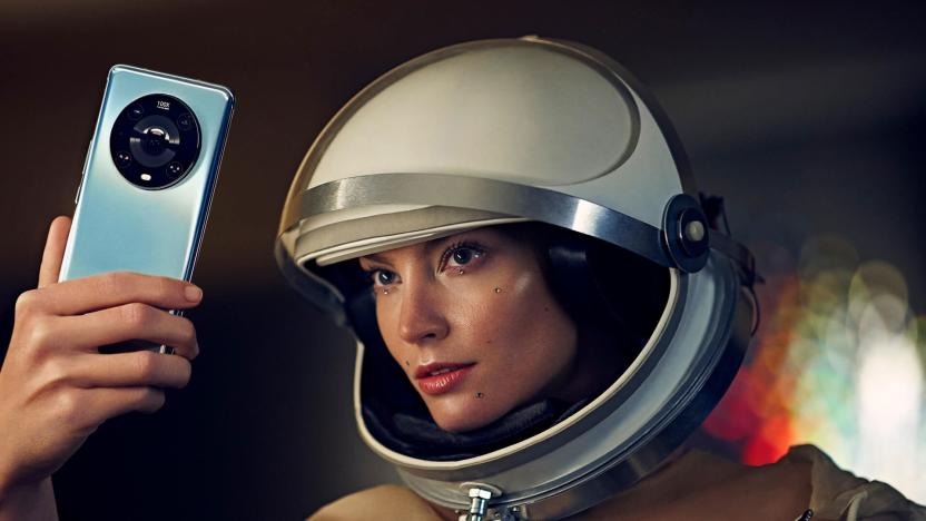 Image of a model holding a Magic4 Pro while wearing a retro space helmet.