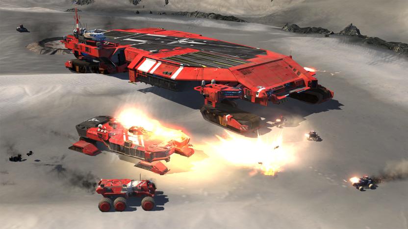 Gameplay screen from the 2016 real-time strategy game ‘Homeworld: Deserts of Kharak.’ A red carrier is surrounded by red assault vehicles in a desert climate. 2016 PC video game graphics.