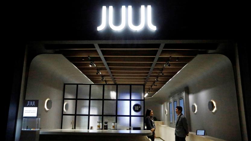 Shopkeepers stand inside a Juul shop at a shopping mall in Jakarta, Indonesia, December 30, 2019. Picture taken December 30, 2019. 