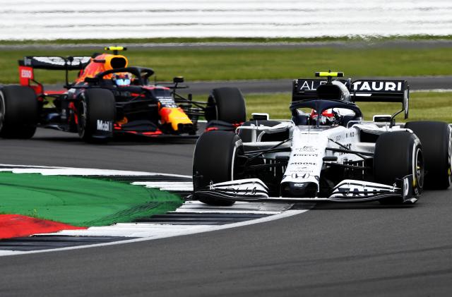 NORTHAMPTON, ENGLAND - AUGUST 02: Pierre Gasly of France driving the (10) Scuderia AlphaTauri AT01 Honda leads Alexander Albon of Thailand driving the (23) Aston Martin Red Bull Racing RB16 on track during the F1 Grand Prix of Great Britain at Silverstone on August 02, 2020 in Northampton, England. (Photo by Rudy Carezzevoli/Getty Images)