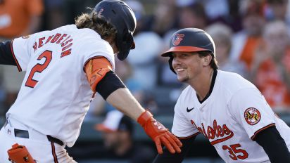 Getty Images - SARASOTA, FL - MARCH 20: Baltimore Orioles shortstop Gunnar Henderson (2) is congratulated by catcher Adley Rutschman (35) after hitting a two-run home run in the second inning of an MLB spring training game against the Philadelphia Phillies on March 20, 2024 at Ed Smith Stadium in Sarasota, Florida. (Photo by Joe Robbins/Icon Sportswire via Getty Images)