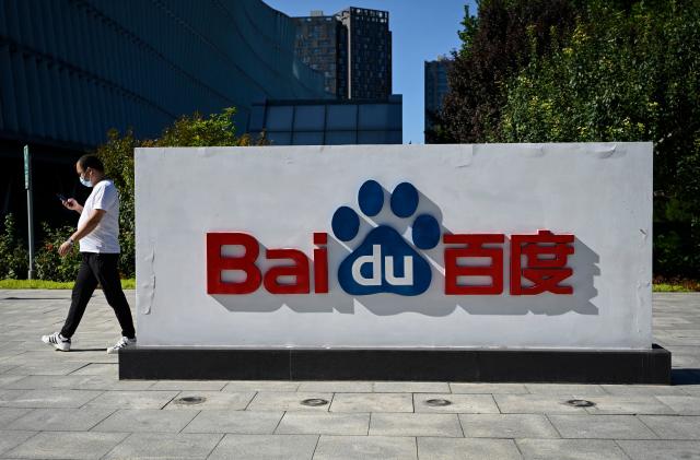 An employee walks past the company logo at Baidu's headquarters in Beijing on September 6, 2022. (Photo by Jade GAO / AFP) (Photo by JADE GAO/AFP via Getty Images)