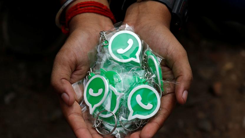 A WhatsApp-Reliance Jio representative displays key chains with the logo of WhatsApp for distribution during a drive by the two companies to educate users, on the outskirts of Kolkata, India, October 9, 2018. Picture taken October 9, 2018. REUTERS/Rupak De Chowdhuri