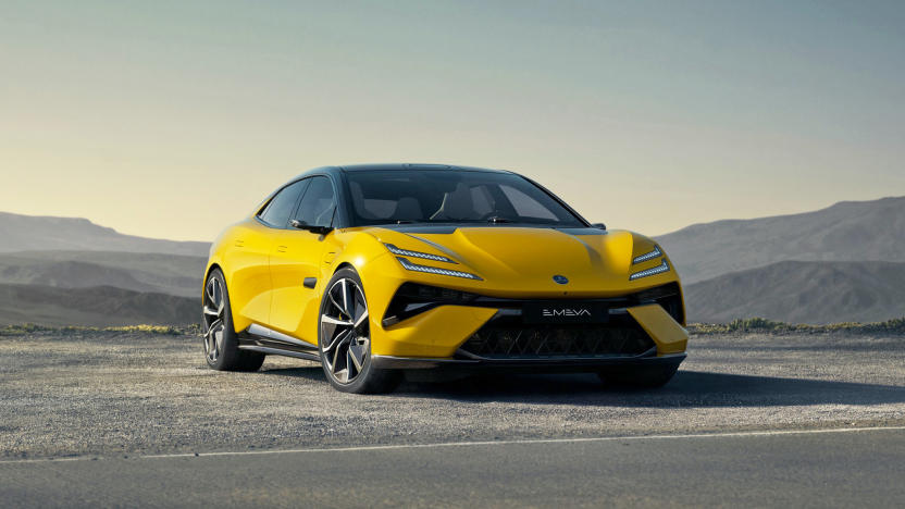 A Lotus Emeya EV in yellow is parked by the side of a desert road with low hills in the distance.