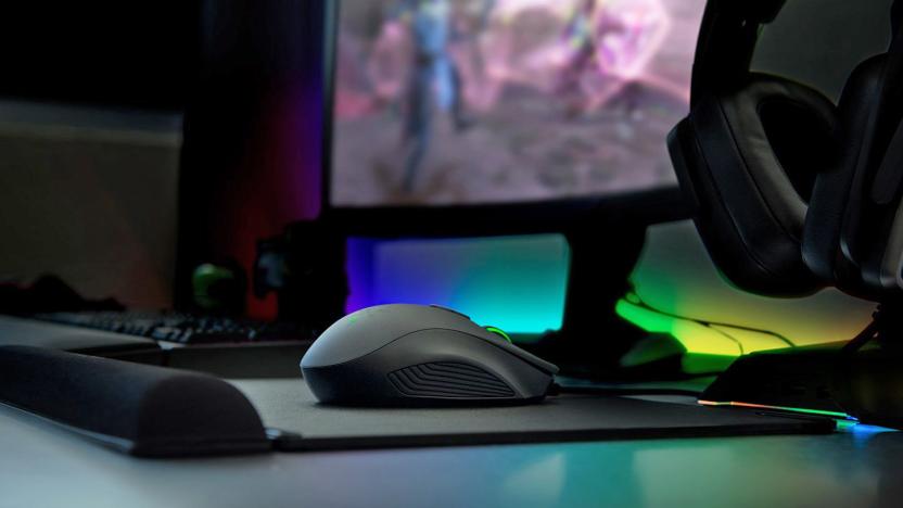 A desktop-level photo focusing on a Razer computer mouse on a mousepad.