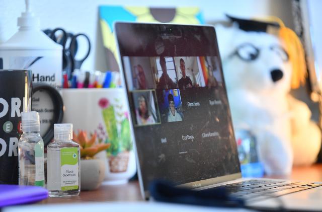 ALBUQUERQUE, NEW MEXICO - AUGUST 17:  Bottles of hand sanitizer sit next to a laptop showing a Zoom meeting as students begin classes amid the coronavirus (COVID-19) pandemic on the first day of the fall 2020 semester at the University of New Mexico on August 17, 2020 in Albuquerque, New Mexico. To help prevent the spread of COVID-19, the university has moved to a hybrid instruction model that includes a mixture of in-person and remote classes. According to the school, about 70 percent of classes are being taught online.  (Photo by Sam Wasson/Getty Images)