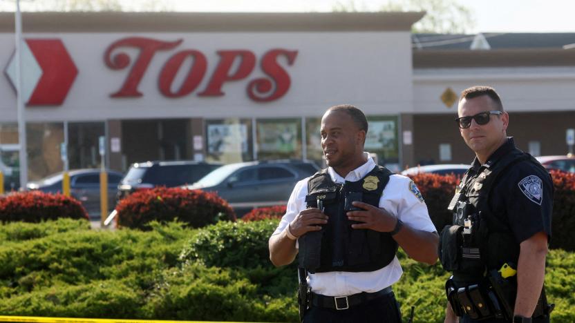 Law-enforcement officers stand guard outside TOPS supermarket following a shooting in Buffalo, New York, U.S. May 15, 2022. REUTERS/Brendan McDermid