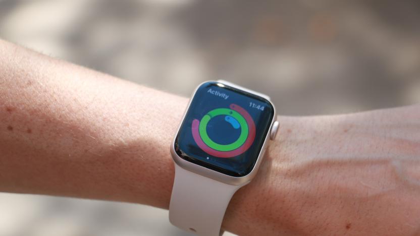 The Apple Watch SE (2022) on a person's wrist, showing the Activity app and rings.