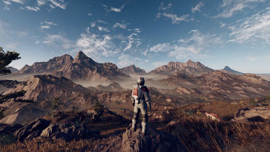 An astronaut, shown from behind, looks out at a rocky landscape in Starfield.