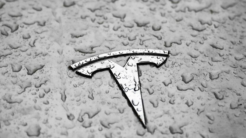 Raindrops are seen on the logo of Tesla car in Milan, Italy on November 25, 2021. (Photo by Jakub Porzycki/NurPhoto via Getty Images)