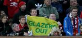 Manchester United fans hold up a sign in protest of the club's owners Joel and Avram Glazer. (Getty Images)