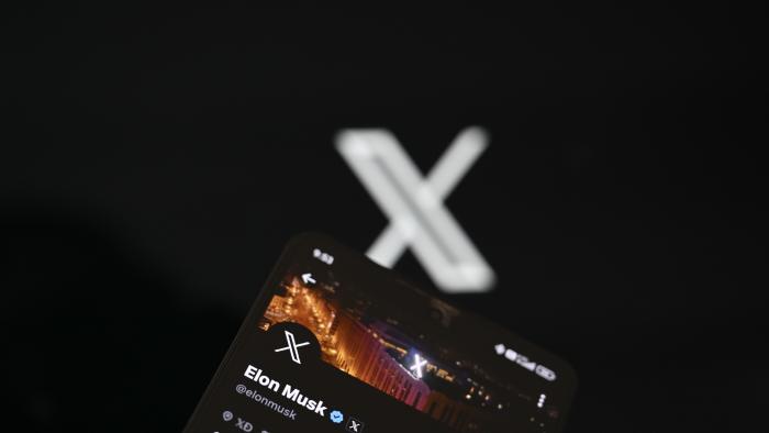 ANKARA, TURKIYE - SEPTEMBER 19: In this photo illustration, 'X' (formerly known as Twitter) Premium account of Elon Musk is displayed on a mobile phone screen in front of a computer screen displaying 'X' logo, in Ankara, Turkiye on September 19, 2023. (Photo by Harun Ozalp/Anadolu Agency via Getty Images)