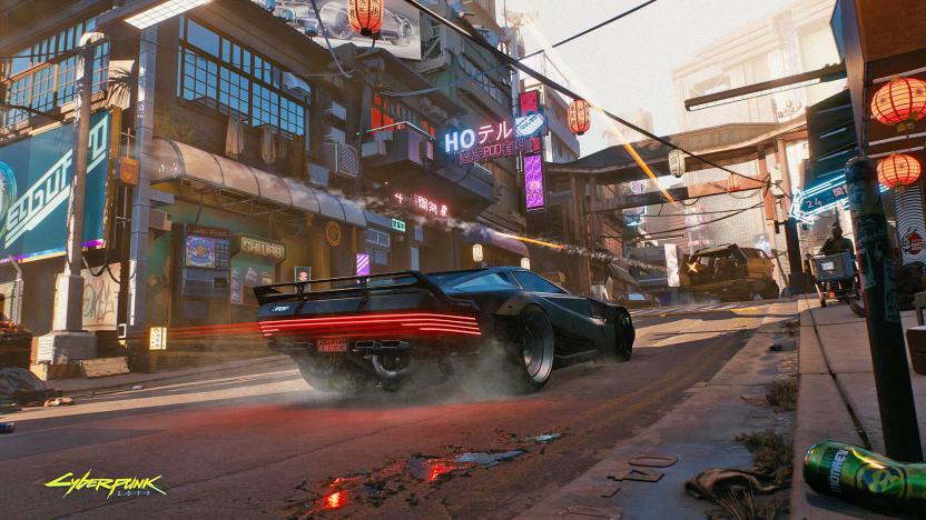 A promotional still from Cyberpunk 2077, showing a car racing up a city street.
