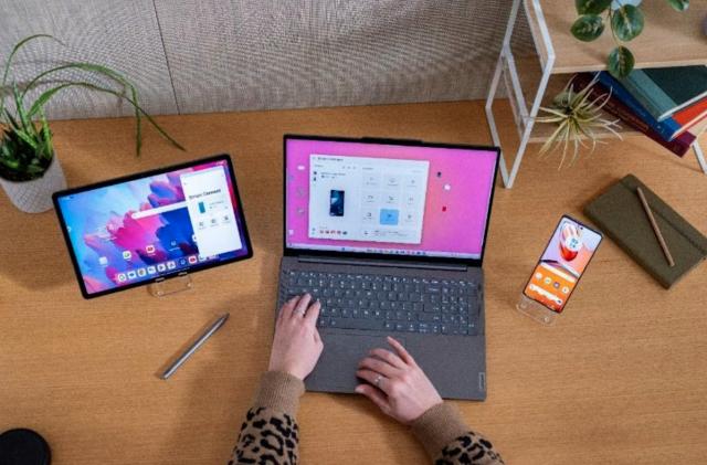 A Lenovo ThinkPad next to a tablet and smartphone. 