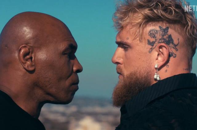 Mike Tyson and Jake Paul stand face to face.